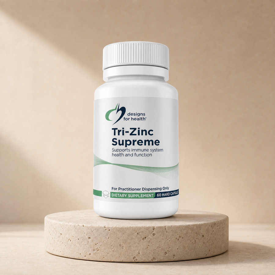 Designs for Health Tri-Zinc Supreme, 60 hard capsules on a beige stone platform