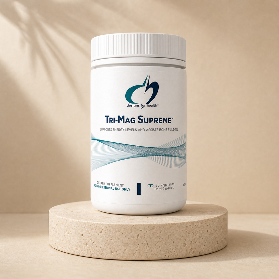 Designs for Health Tri-Mag Supreme, 120 vegetarian hard capsules on a beige stone platform